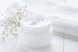 Natural facial cream healthy organic cosmetic product wellness and relaxation makeup mask in glass jar with towel on white background