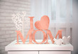 © Africa Studio - I love mom inscription made of wooden letters with heart on light brick wall and window background