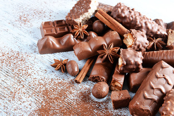 Wall Mural - Chocolate sweets with powder on wooden background