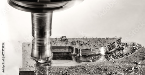 Fotografie, Obraz Milling cutter work with splinters flying off, monochrome versio