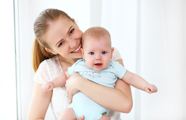 happy family mother playing with baby