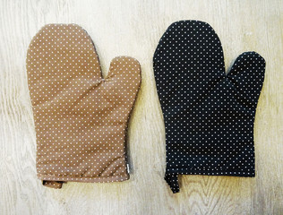 Top view of brown and black oven mitts