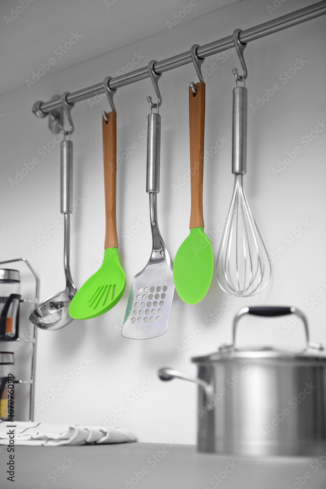 Set of cutlery hanging on wall in the kitchen