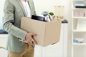 Businessman with moving box in office