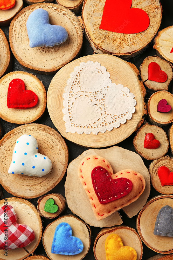 Valentine's Day concept. Different handmade hearts on wooden stumps background