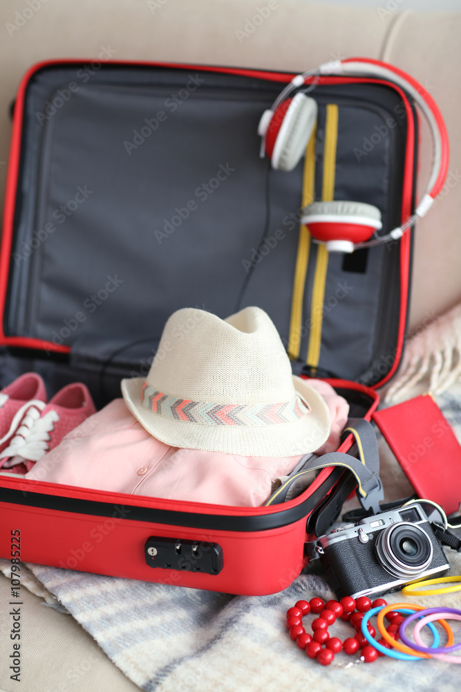 Woman's clothes in a red suitcase, close up