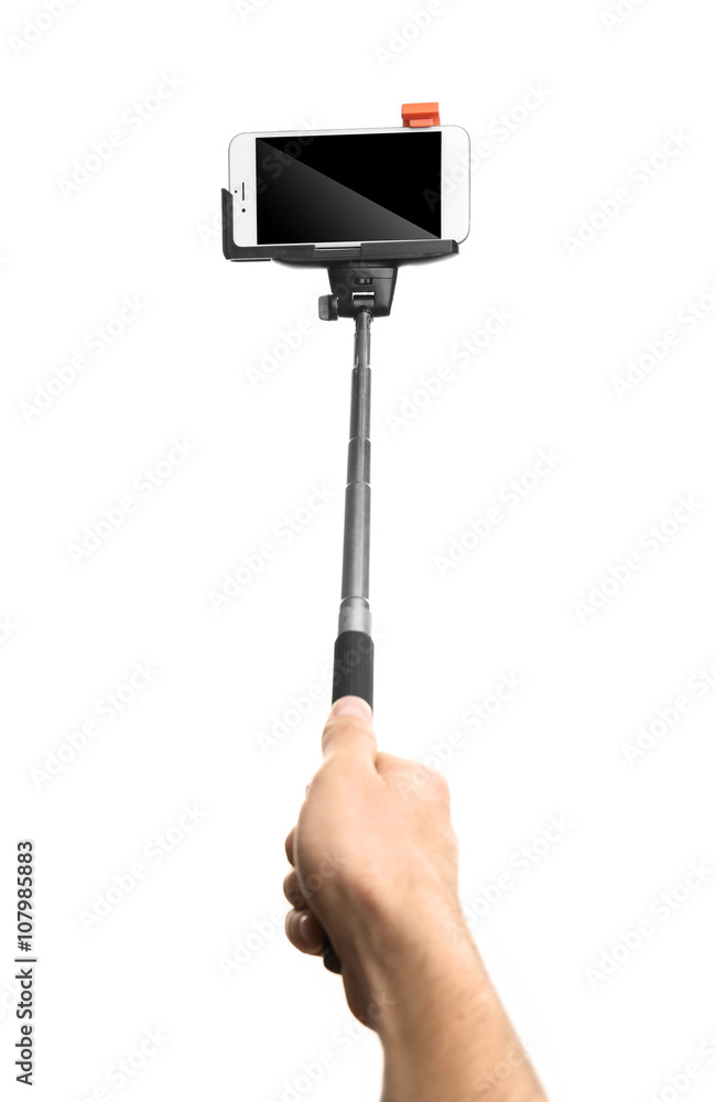 Hand holding stick for making photo with mobile phone, isolated on white