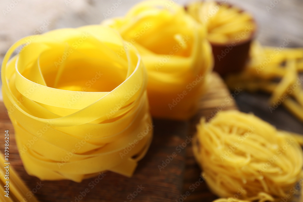 Uncooked pasta on cutting board, closeup