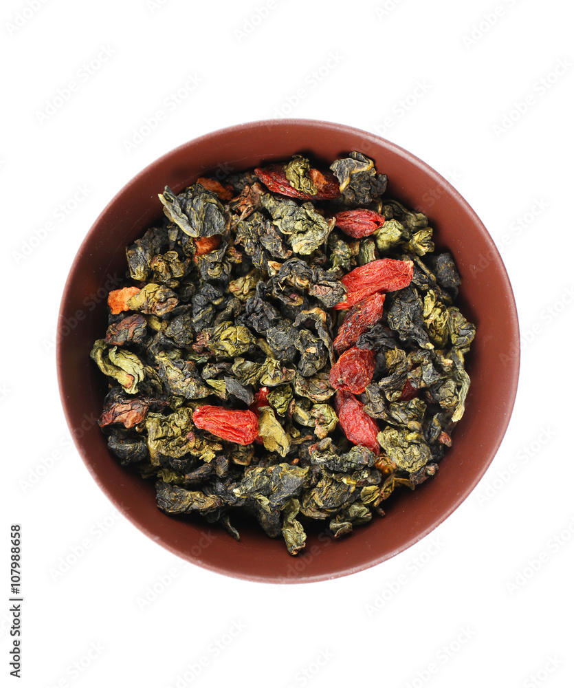 Dry tea in saucer isolated on white
