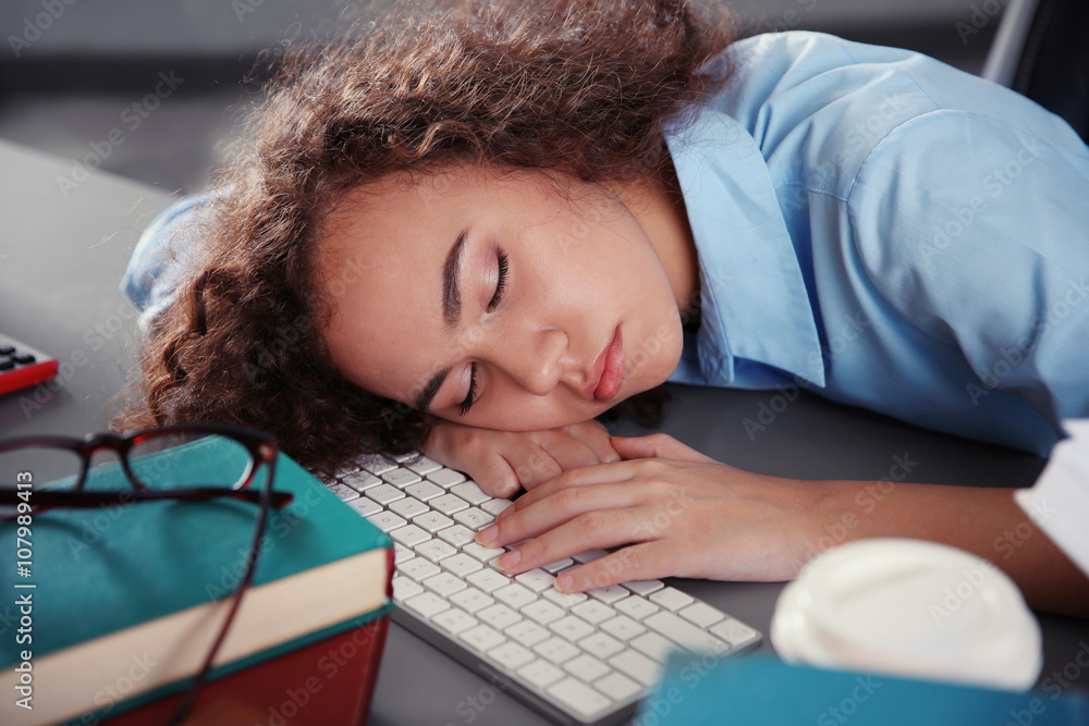 Tired beautiful girl sleeping on table