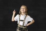 Fototapeta Łazienka - sweet junior blond schoolgirl smiling happy in front of school classroom blackboard