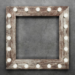 Wall Mural - Wooden frame on concrete background illuminated by light bulbs. 3D rendering