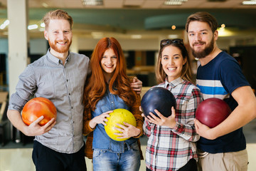 Wall Mural - cheerful friends bowling together