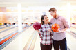© NDABCREATIVITY - Couple enjoying bowling together