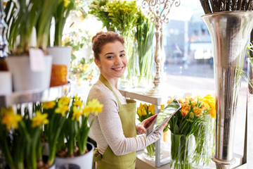 Wall Mural - woman with tablet pc computer at flower shop