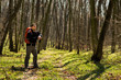 © Aleksey - Male hiker looking to the side walking in forest