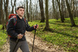 © Aleksey - Male hiker looking to the side walking in forest