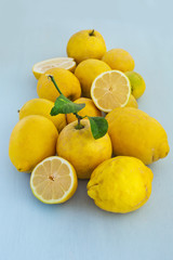 Organic lemons fruits on a blue wooden background . Healthy vegetarian food.