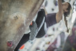 © John Fedele/Blend Images - Close up of athlete climbing rock wall in gym