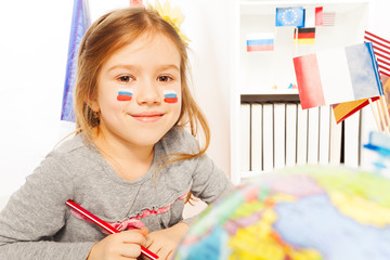 Wall Mural - Russian schoolgirl learning geography at the class