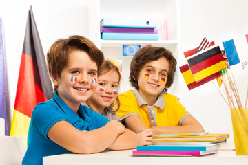 Wall Mural - Happy children at the classroom studying geography