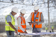 © Resolution Productions/Blend Images - Architects reading blueprints at construction site