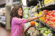 © Marc Romanelli/Blend Images - Hispanic woman shopping at grocery store