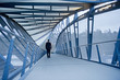 © Pete Saloutos/Blend Images - Caucasian businessman walking on sky bridge