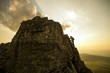 © Aleksander Rubtsov/Blend Images - Male hiker climbing on rock formation