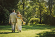 © Inti St Clair/Blend Images - Caucasian bride and groom walking in grass