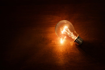 Poster - light bulb on dark background