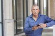 © Kevin Dodge/Blend Images - Caucasian businessman using cell phone in city