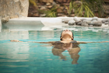 Hispanic Woman Swimming In Pool