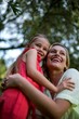 © Wavebreak Media - Mother embracing daughter in yard