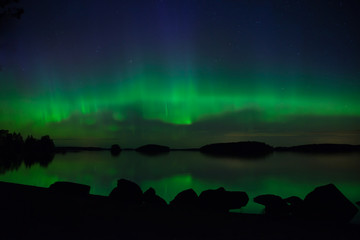 scenic view of a lake landscape with northern lights