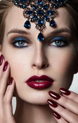 Beauty Woman in jewelry. Professional Makeup. Burgundy red Lipst