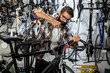 © Wavebreak Media - Bike mechanic checking at bicycle