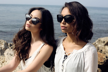 Wall Mural - beautiful girls with dark hair wears casual elegant clothes and sunglasses