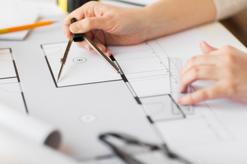 Poster - close up of hands with compass measuring blueprint