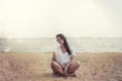 © kuzmichstudio - Woman in a tunic on the beach happy smiles and relaxes in the su