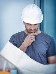 Architect builder studying layout plan of the rooms