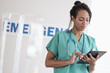 © JGI/Tom Grill/Blend Images - Mixed race nurse using digital tablet in hospital