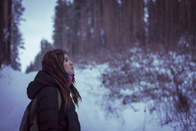 Caucasian Woman Standing In Snowy Forest