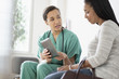 © JGI/Tom Grill/Blend Images - Nurse and patient using digital tablet