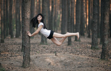 Caucasian Woman Floating In Forest