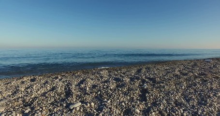 Wall Mural - 4k Crane movement from the bottom to the top near a Blue empty Sea
