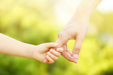 Wall Mural - Father and daughter hands outdoors