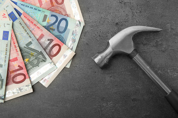 Wall Mural - Money with hammer on grey background, close up