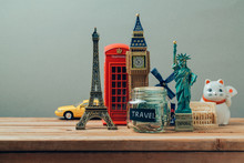 Travel And Tourism Concept With Souvenirs From Around The World. Planning Summer Vacation, Money Budget Trip Concept. Saving Money For Vacation.