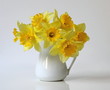 Bouquet of yellow daffodils flowers in a vase. Bouquet of spring yellow narcissus flowers in a vase. Floral home decoration.